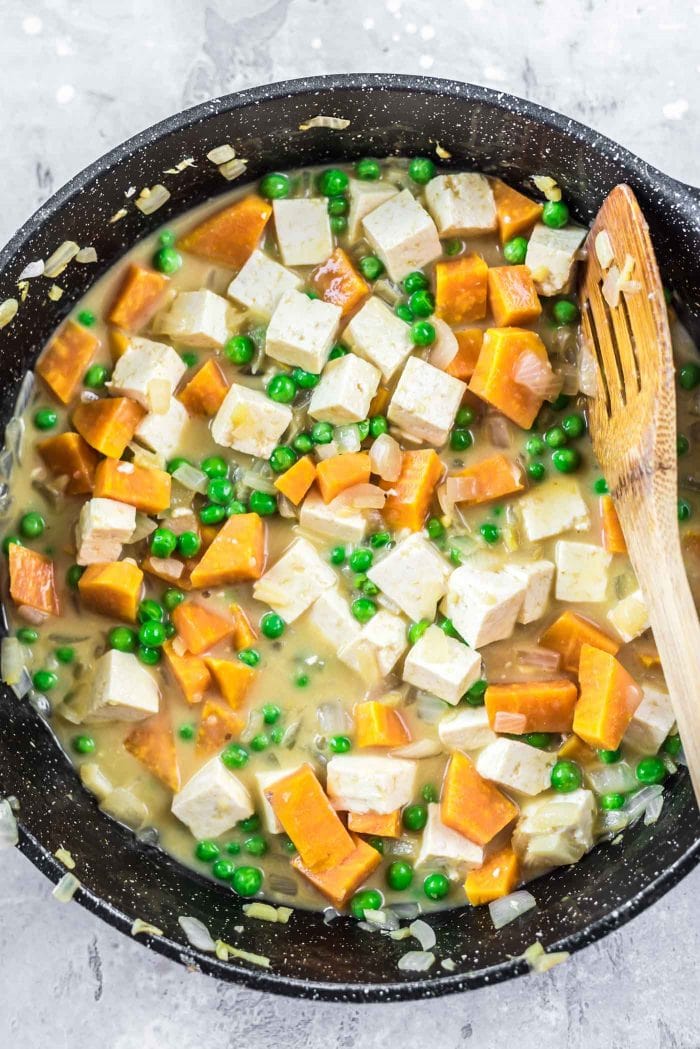 Sweet potato curry being cooked in a black saucepan.