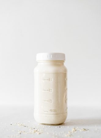 A sealed glass jar of homemade hemp milk.