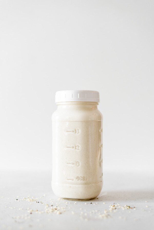 A sealed glass jar of homemade hemp milk.