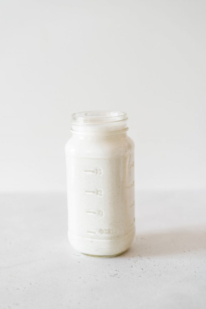 Creamy hemp milk in a glass jar.