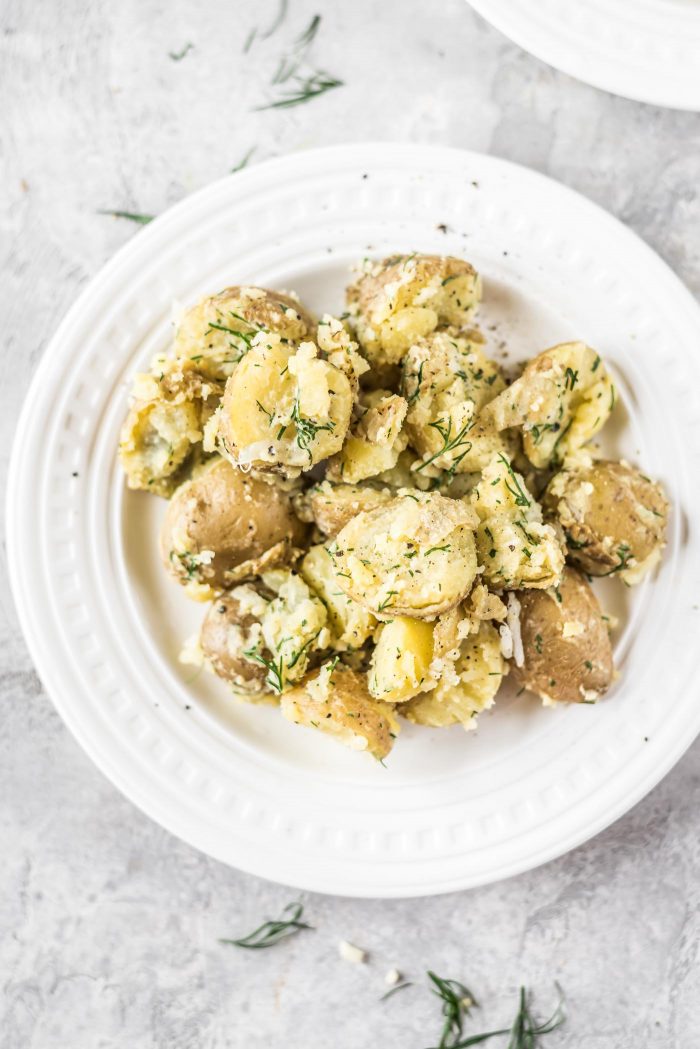 Healthy potato salad with dill on a white plate.