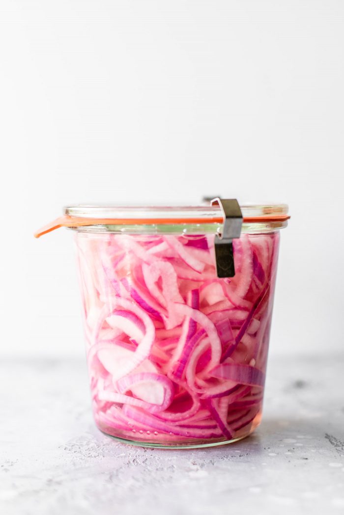 Weck jar filled with pickled red onions.