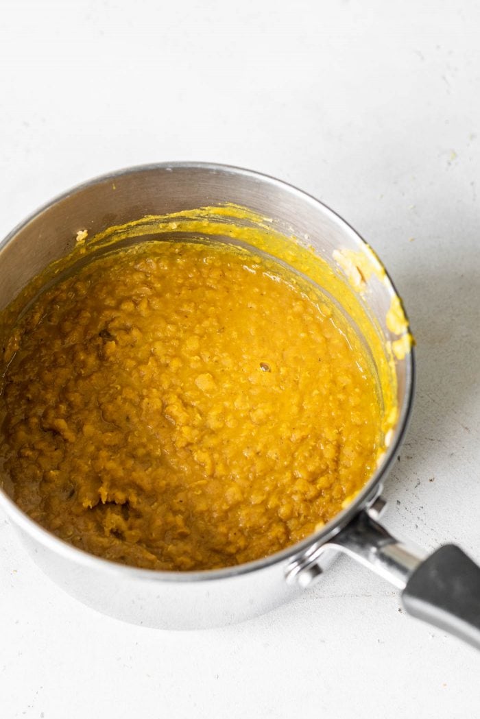 Curried red lentils in a small saucepan.