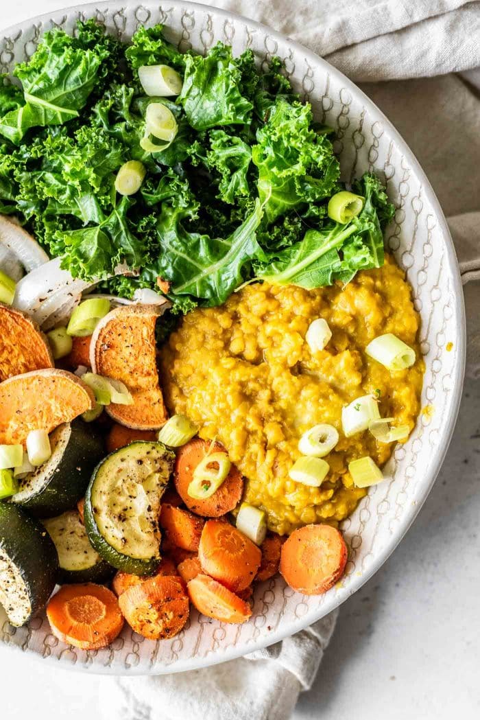 Curried red lentils with kale and roasted vegetables.