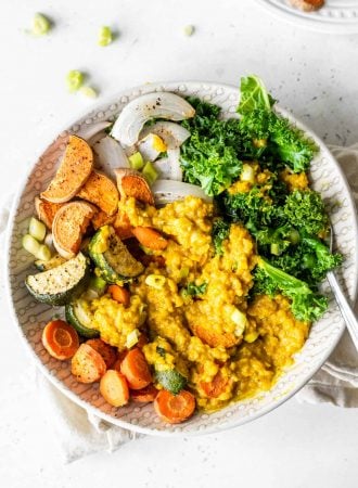 Curried lentils, kale and roasted vegetables in a bowl.