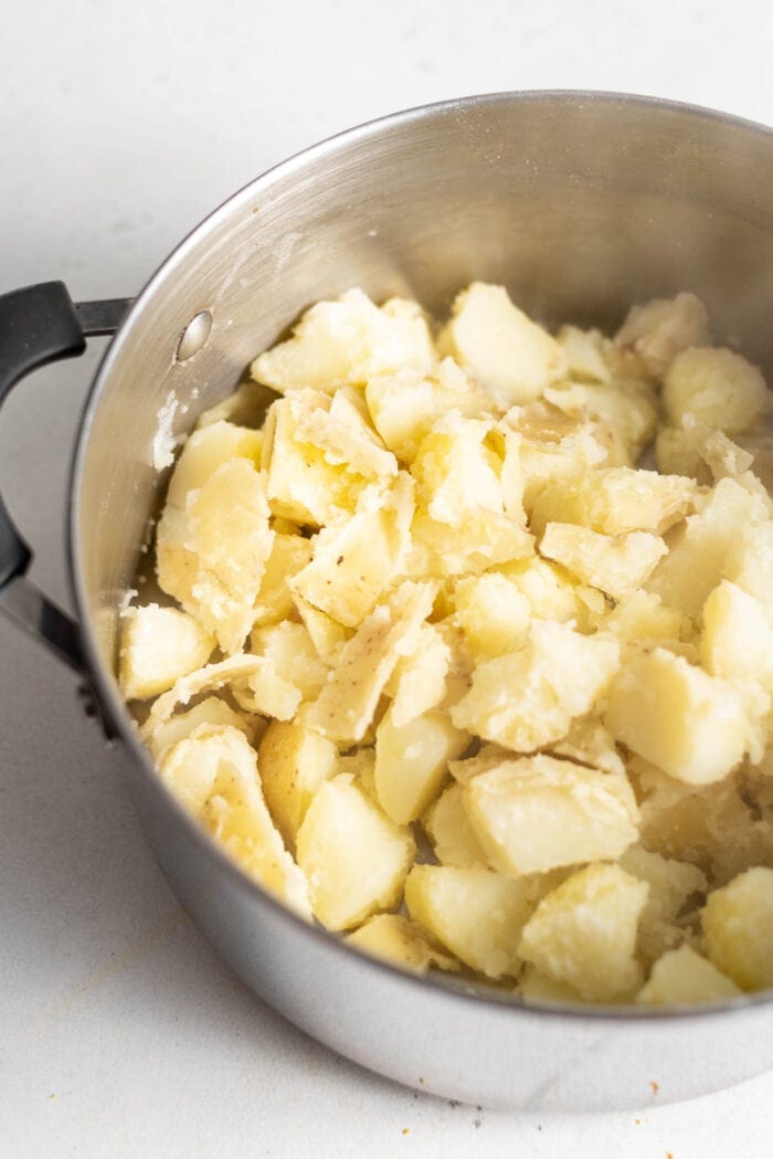 Cooked chopped potatoes in a large stockpot.