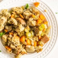 Plant-based stuffing made with cubed bread and vegetables on a small plate.