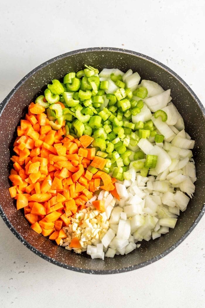Diced carrot, onion, celery and garlic in a skillet.