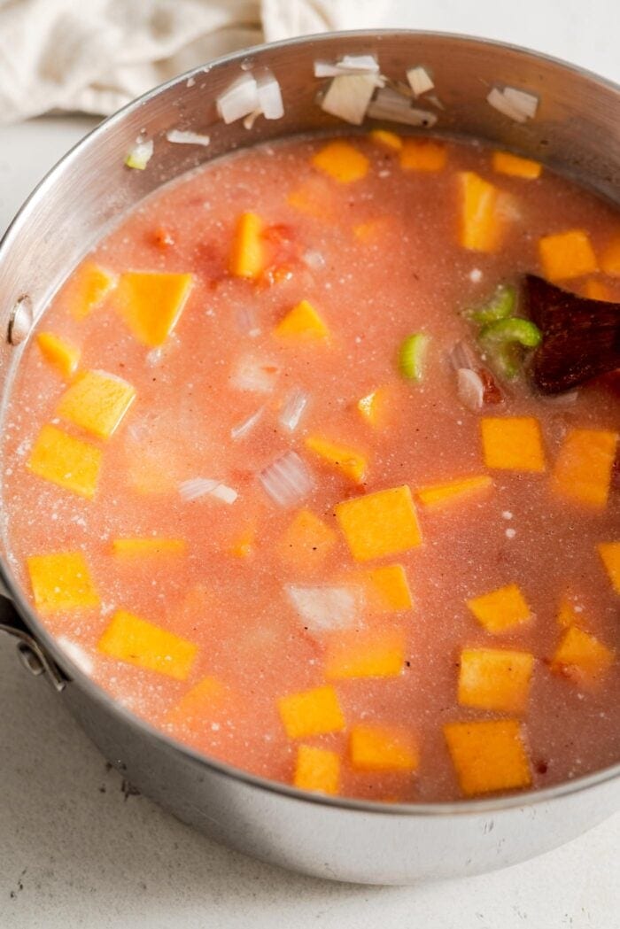 Uncooked butternut squash red lentil soup in a large soup pot.