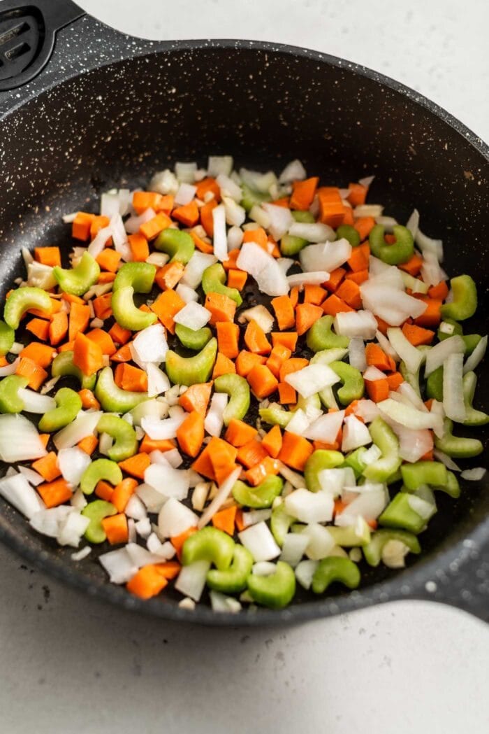Carrot, onion, garlic and celery in a skillet with sesame oil.