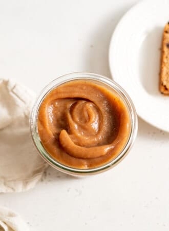 Thick apple butter in a glass jar.