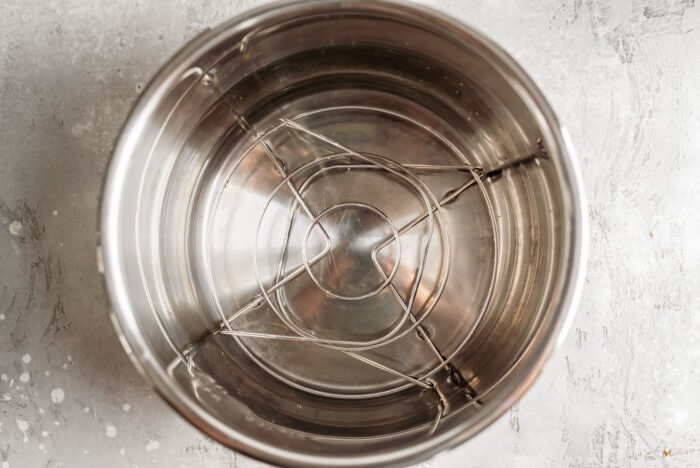 Overhead image of an Instant Pot filled with 1 cup cold water and a trivet.