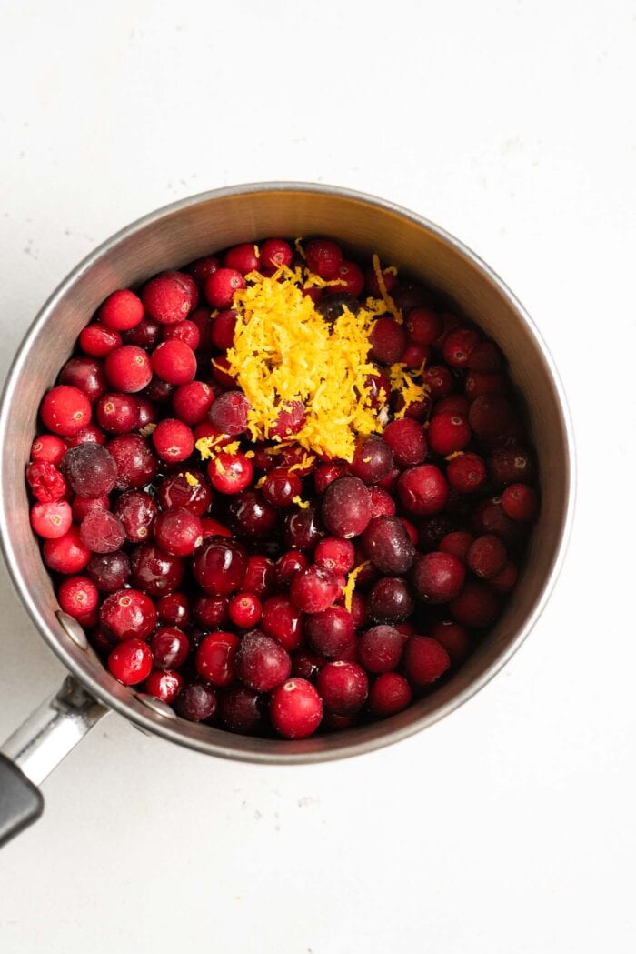 Whole cranberries, maple syrup and orange zest in a medium-sized saucepan.