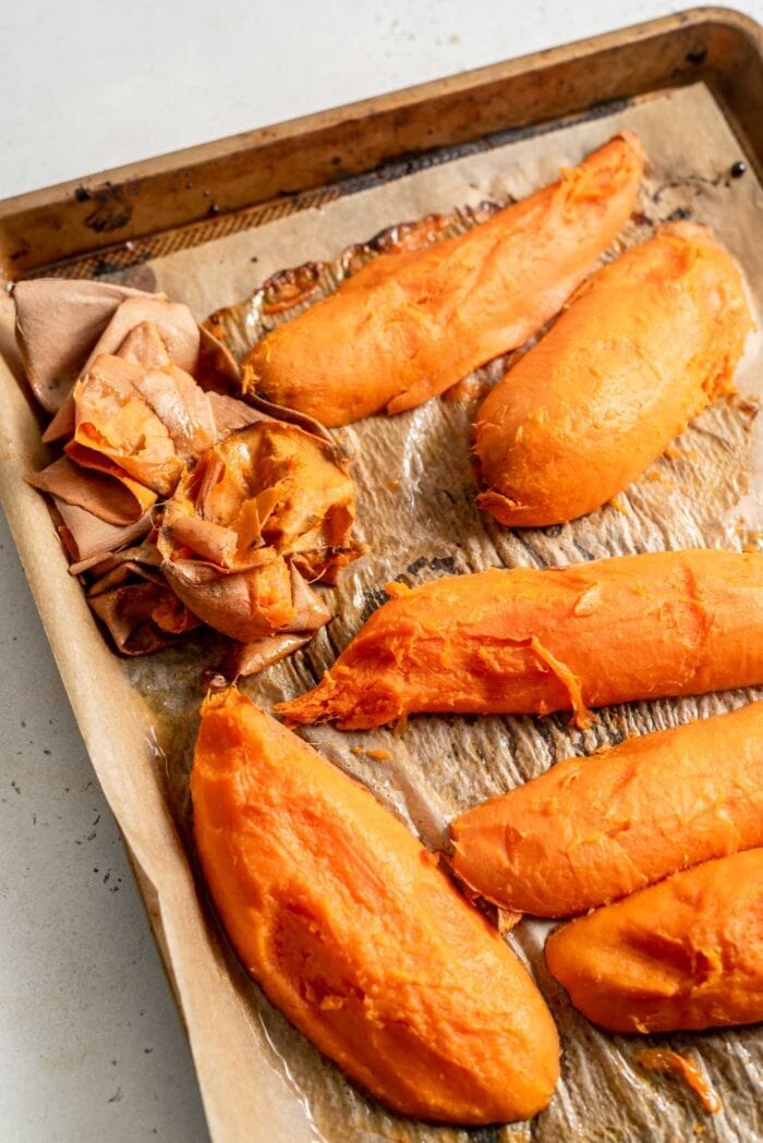 Roasted sweet potato with the skin removed on a baking tray.