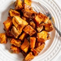 Miso glazed sweet potato on a small white plate.