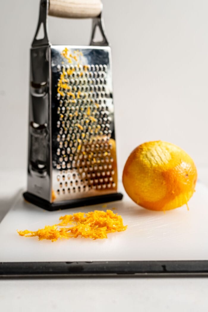 Grated orange zest on a cutting board.