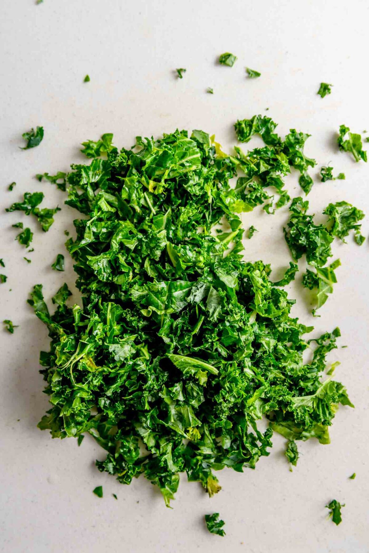 Finely chopped kale on a cutting board.