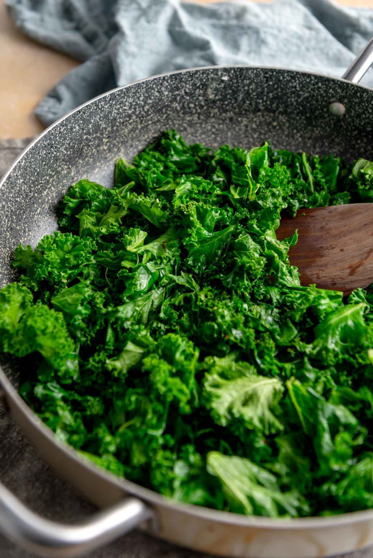 Cooked steamed kale in a large pan.