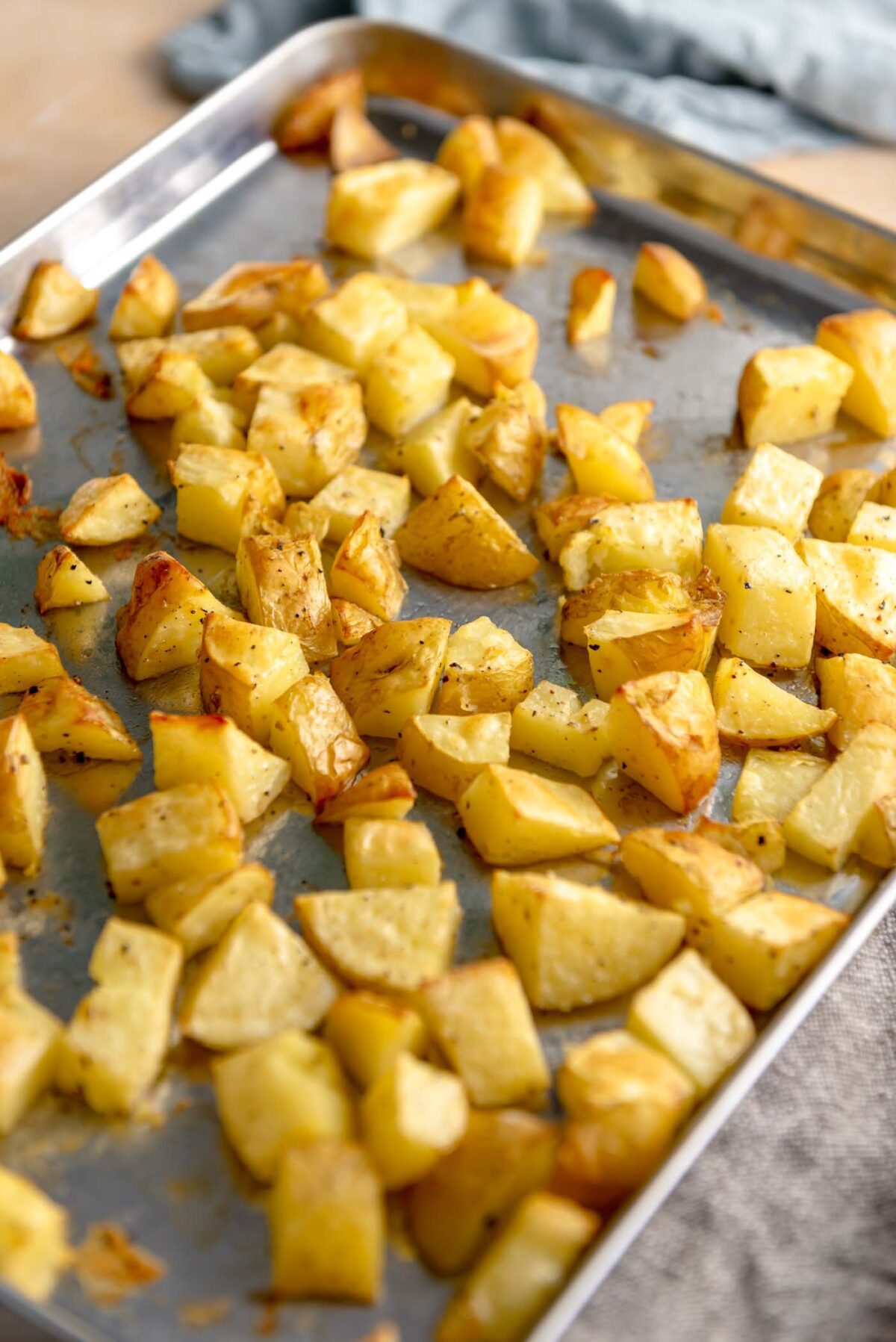 Roasted potato chunks on a baking sheet.