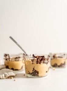 3 peanut butter mousse parfaits in small glass jars.