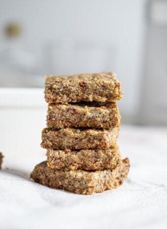 Stack of baked tahini bars on a mobile surface.