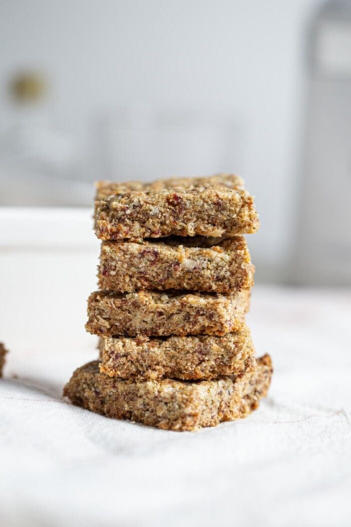 Stack of baked tahini bars on a mobile surface.