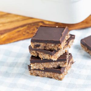 Stack of chocolate topped almond joy bars.