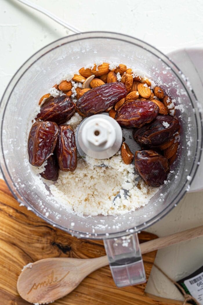 Medjool dates and almonds in a food processor with coconut.