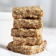 Stack of baked tahini bars on a mobile surface.