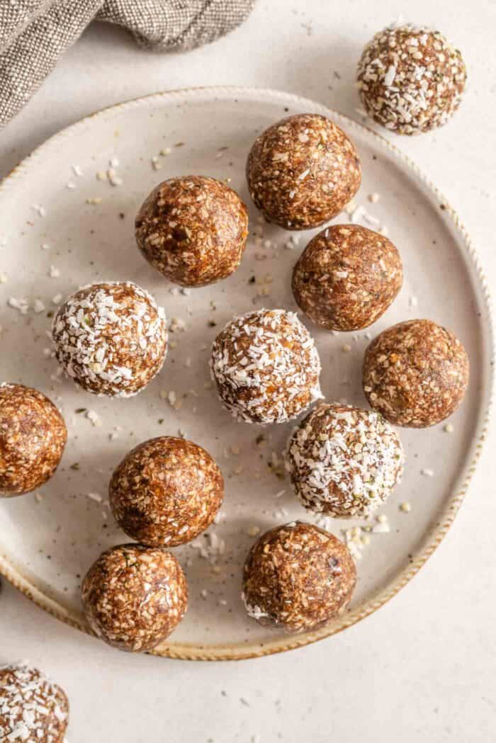A plate of energy balls rolled in shredded coconut.