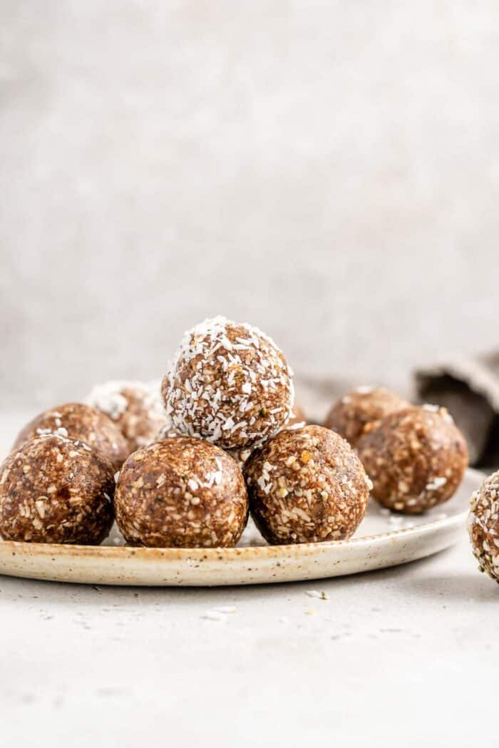 A stack of raw energy balls on a plate.
