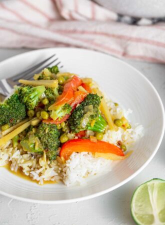 A bowl of green curry over rice.