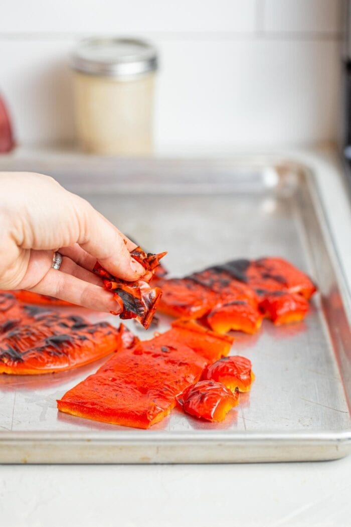 Peeling the skin off roasted red peppers.