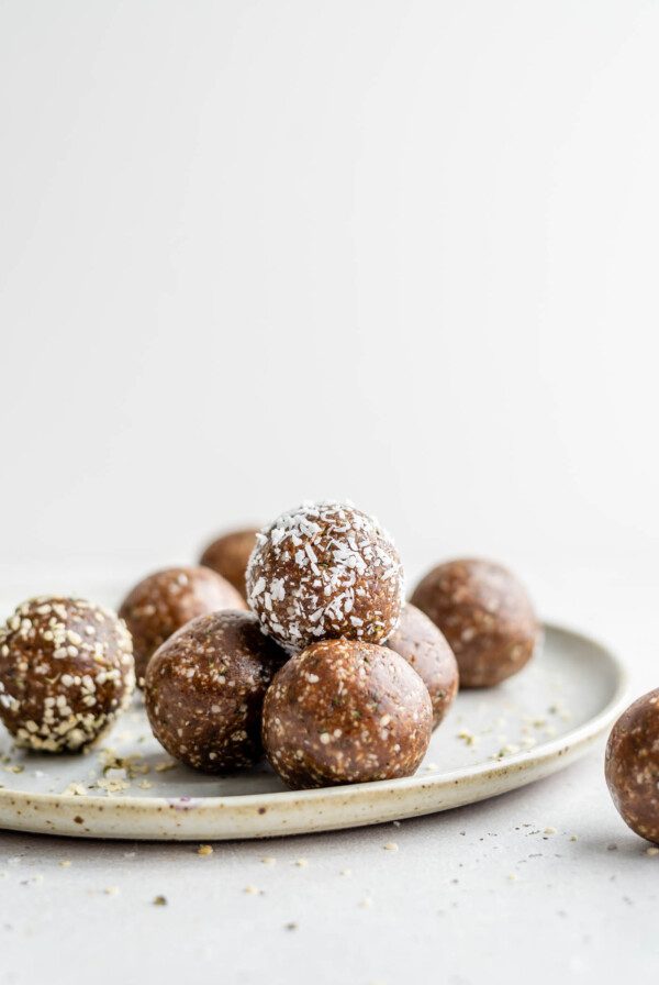 A stack of raw energy balls on a plate.