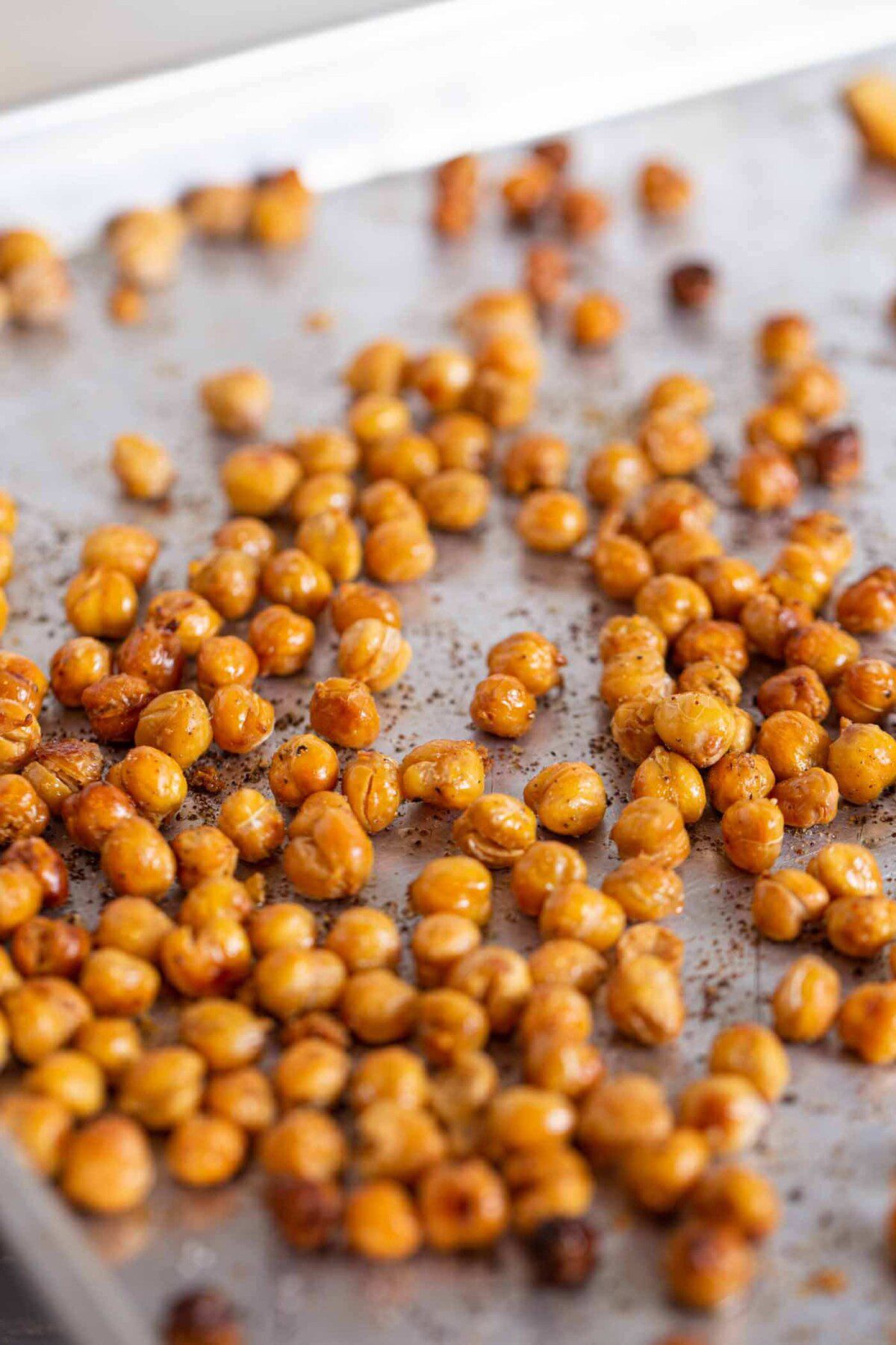 Roasted chickpeas on a baking tray.