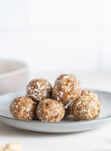 A pile of raw energy balls on a small plate.