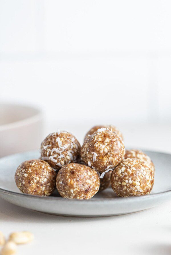 A pile of raw energy balls on a small plate.