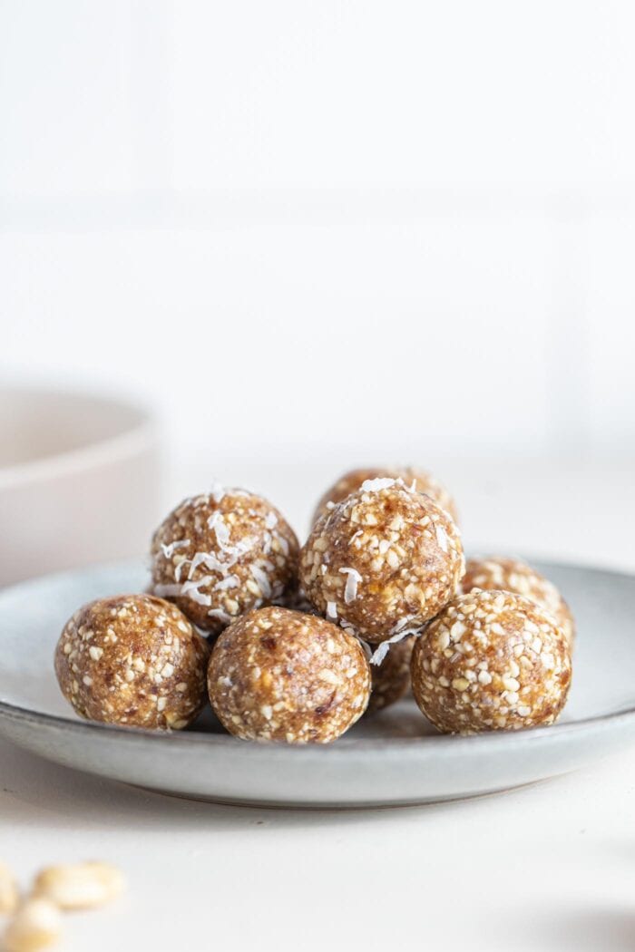 A pile of raw energy balls on a small plate.