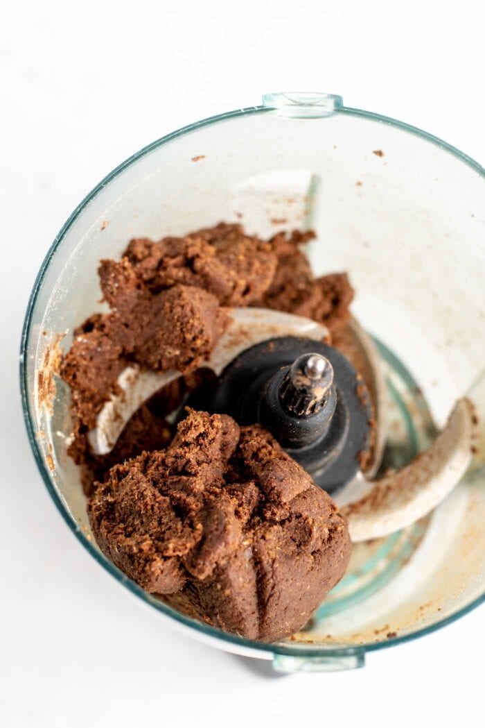 Raw chocolate energy ball dough in a food processor.