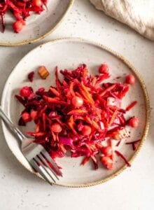 Beet, carrot and chickpea salad on a plate with a fork.