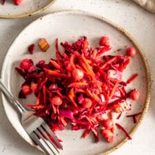 Beet, carrot and chickpea salad on a plate with a fork.