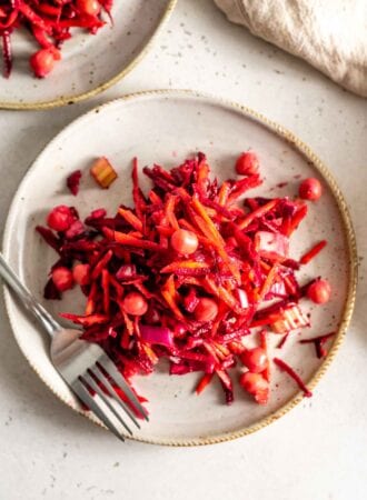 Beet, carrot and chickpea salad on a plate with a fork.