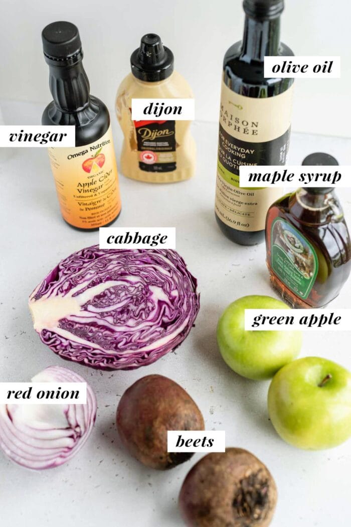 Labelled ingredients for a beet, apple and cabbage salad.