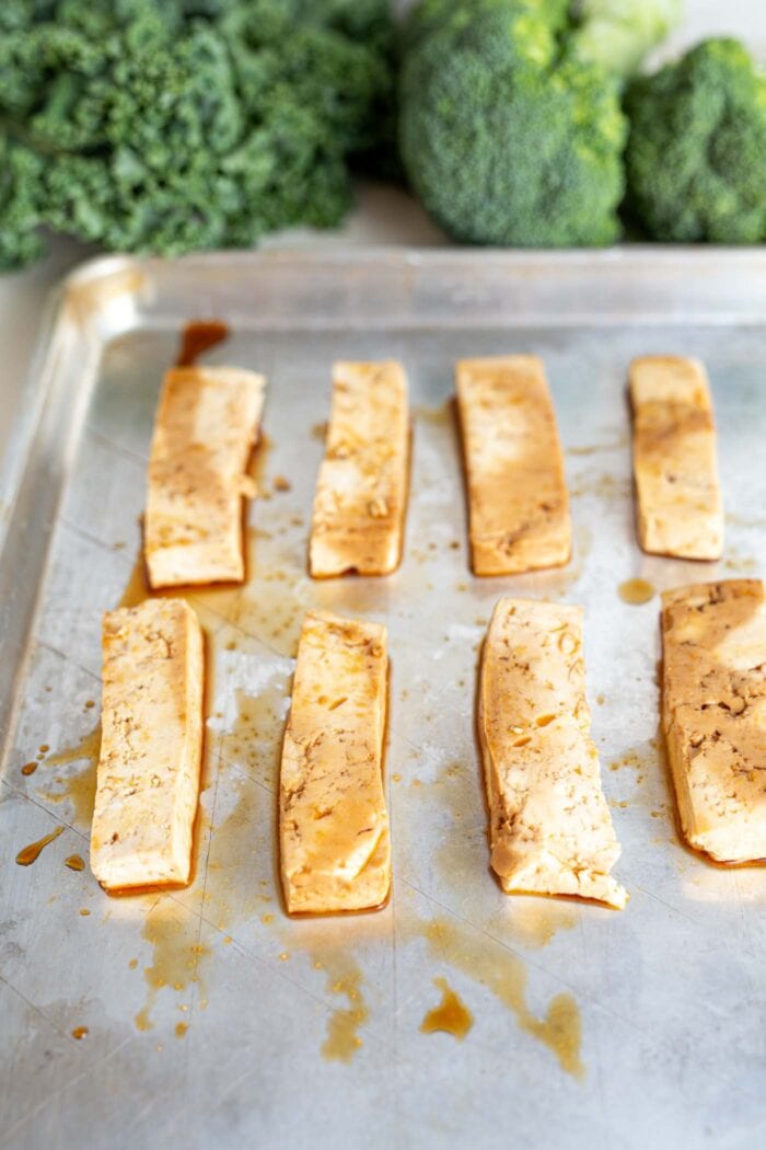 Slabs of marinated tofu on a baking tray.