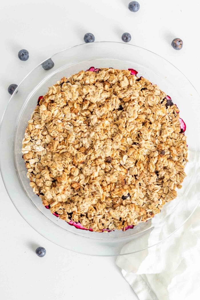 A baked blueberry crisp in a pie dish.
