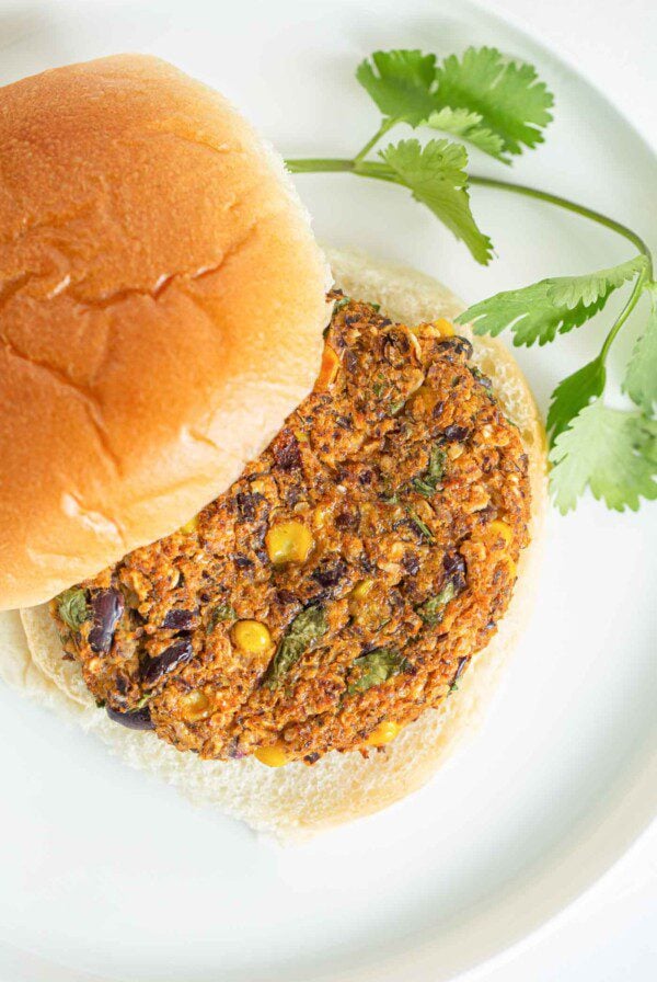 A sweet potato burger pattie on a bun.