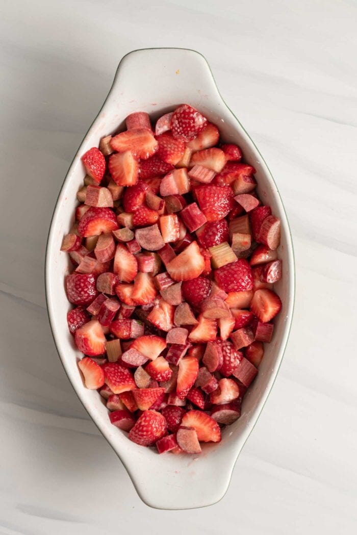 Chopped strawberries and rhubarb in a baking dish.