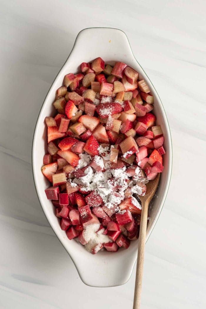 Chopped strawberries and rhubarb in a baking dish.