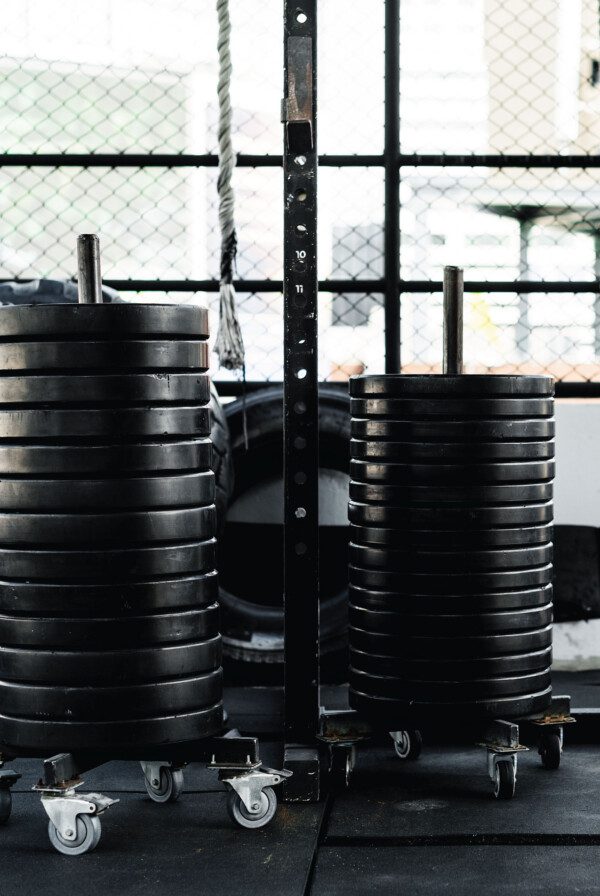 Two stacks of 25 lb weight plates in a gym.