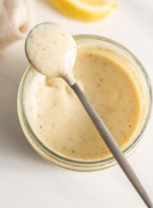A small spoonful of creamy caesar salad dressing.